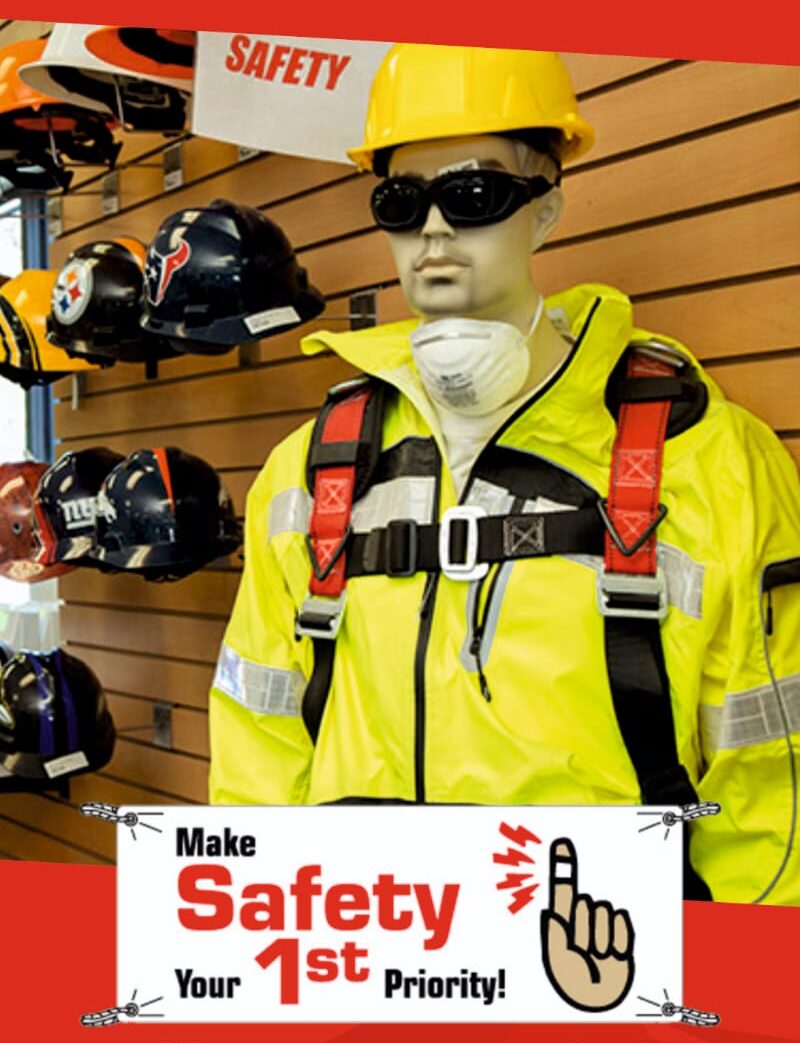 Proper personal protective equipment (PPE) is essential—this mannequin showcases high-visibility gear, a safety harness, and respiratory protection as part of a workplace safety awareness display.